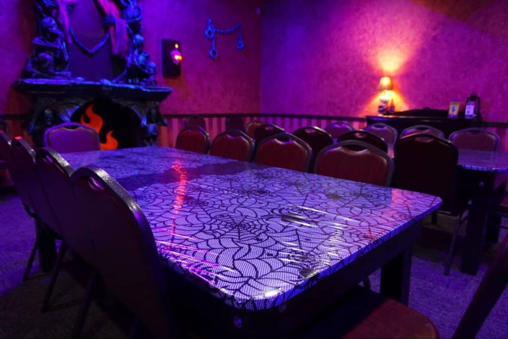 Eatontown Fundraiser Event 3 Decorated tables in a private haunted mansion room at a monster mini golf location.