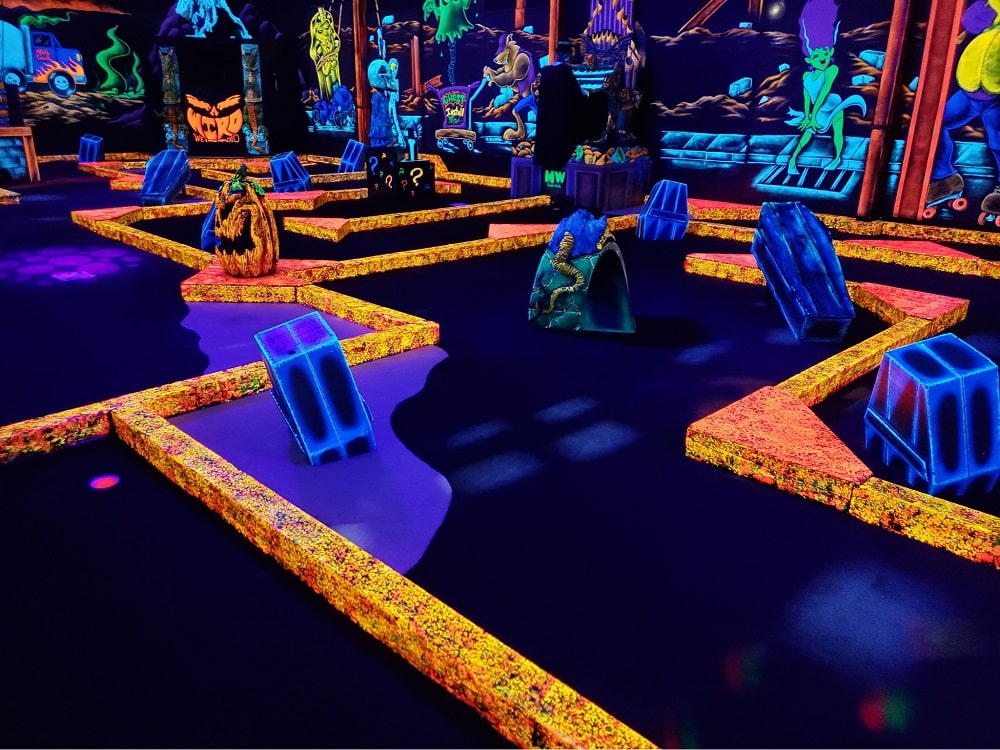 A glow-in-the-dark golf course at monster mini golf.